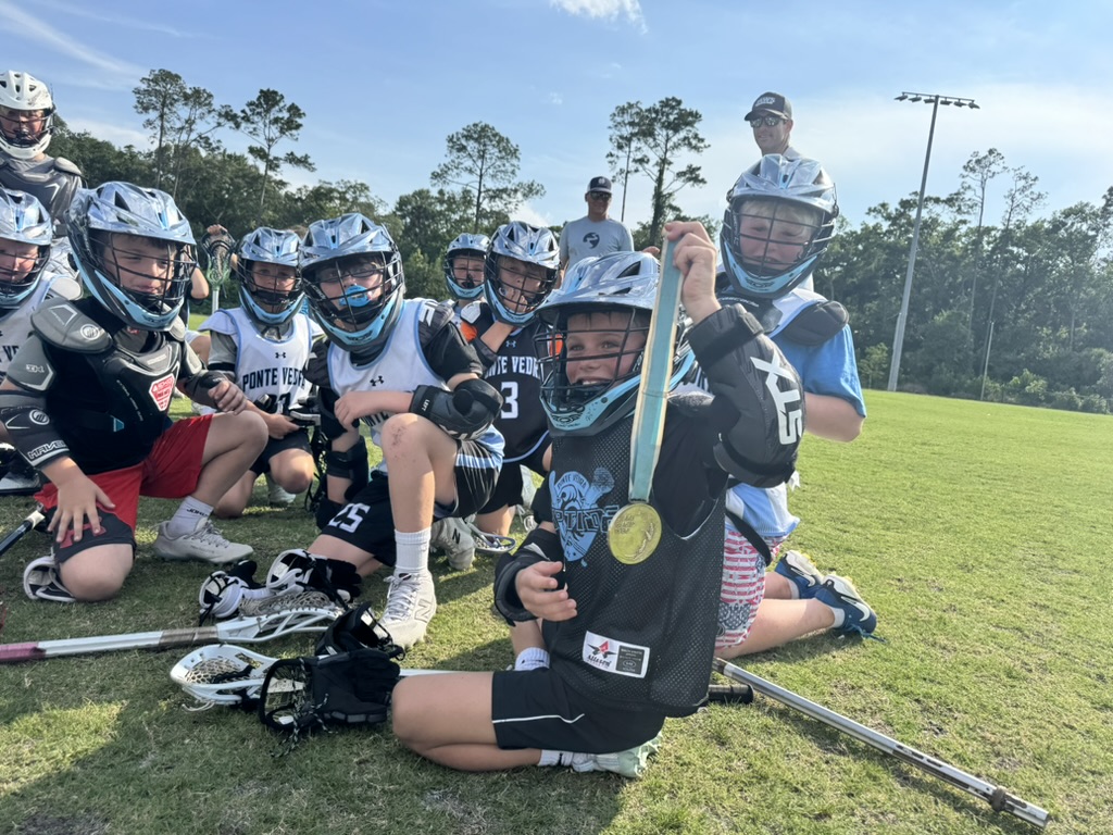 Young Boys Jaws teammates celebrating with a medal