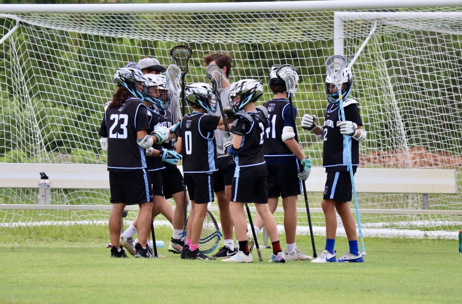 Young Ponte Vedra players gathering around their goalie after a game