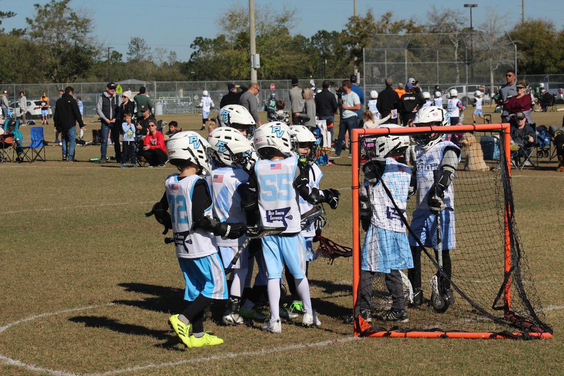 Young Ponte Vedra Riptide teammates gathering around their goalie